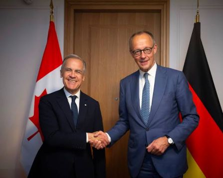 Friedrich Merz and Mark Carney shaking hands
